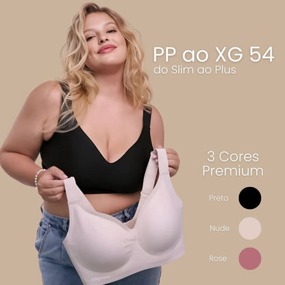 Modelo plus size vestindo o Sutiã Premium Reforçado Cygnuss na cor preta, segurando a versão nude. Texto destaca os tamanhos PP ao XG 54 e as cores disponíveis: preto, nude e rose.