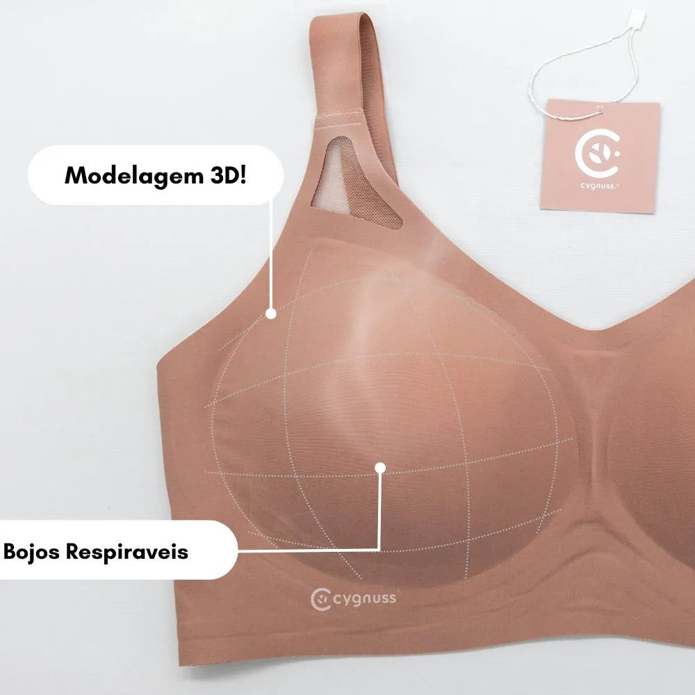 Sutiã Cygnuss com modelagem 3D, destacando bojos respiráveis e estrutura anatômica para sustentação confortável. A imagem inclui marcações que evidenciam o design ergonômico do produto