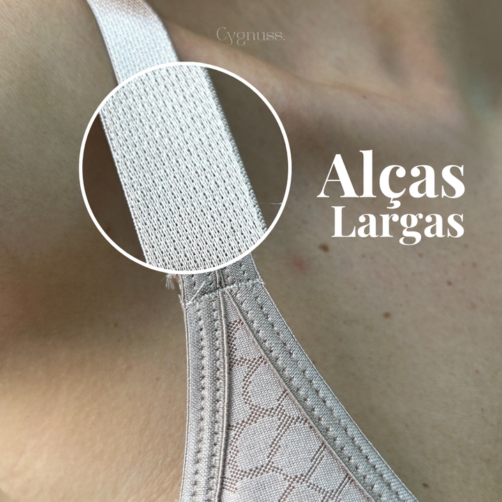Close-up das alças largas do Sutiã Trend Curves Cygnuss x Lupo, com destaque circular ampliando a textura do elástico e a legenda “Alças Largas” em branco sobre fundo neutro.


